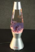 A 1960s style Mathmos lava lamp, the oil contained inside of purple hue, bearing label 'Mathmos,