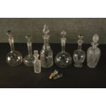 A collection of six cut crystal decanters and a perfume bottle with stopper. H.36 Dia. 10cm. (
