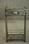 An industrial steel cabinet, with a single drawer over a divider, the sides with a lattice mesh,