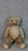 A 19th century large mohair humpback teddy bear with jointed limbs. H.51cm