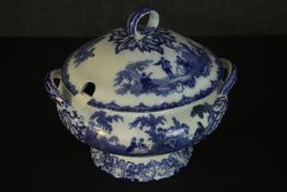 A Doulton Watteau pattern blue and white china tureen, the lid with a loop handle, the body with two