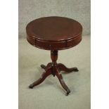 A reproduction mahogany drum occasional table, the circular top with two drawers, on a vase turned