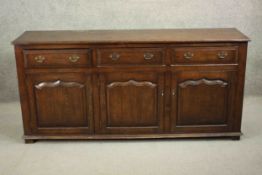 An 18th century style oak sideboard, of rectangular form, with three short drawers over three