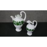 A circa 1970s Meissen porcelain coffee pot and milk jug, decorated with a green vine pattern, the