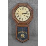 An early 20th century Oak cased "REGULATOR" wall clock, by Waterbury Clock Co., USA, enamel dial and