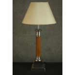 A Classical column style table lamp, with a reeded stem, and nickel plated mounts, on a square