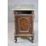A 19th century Italian walnut bedside cabinet, with a marble top, over a missing drawer, above a