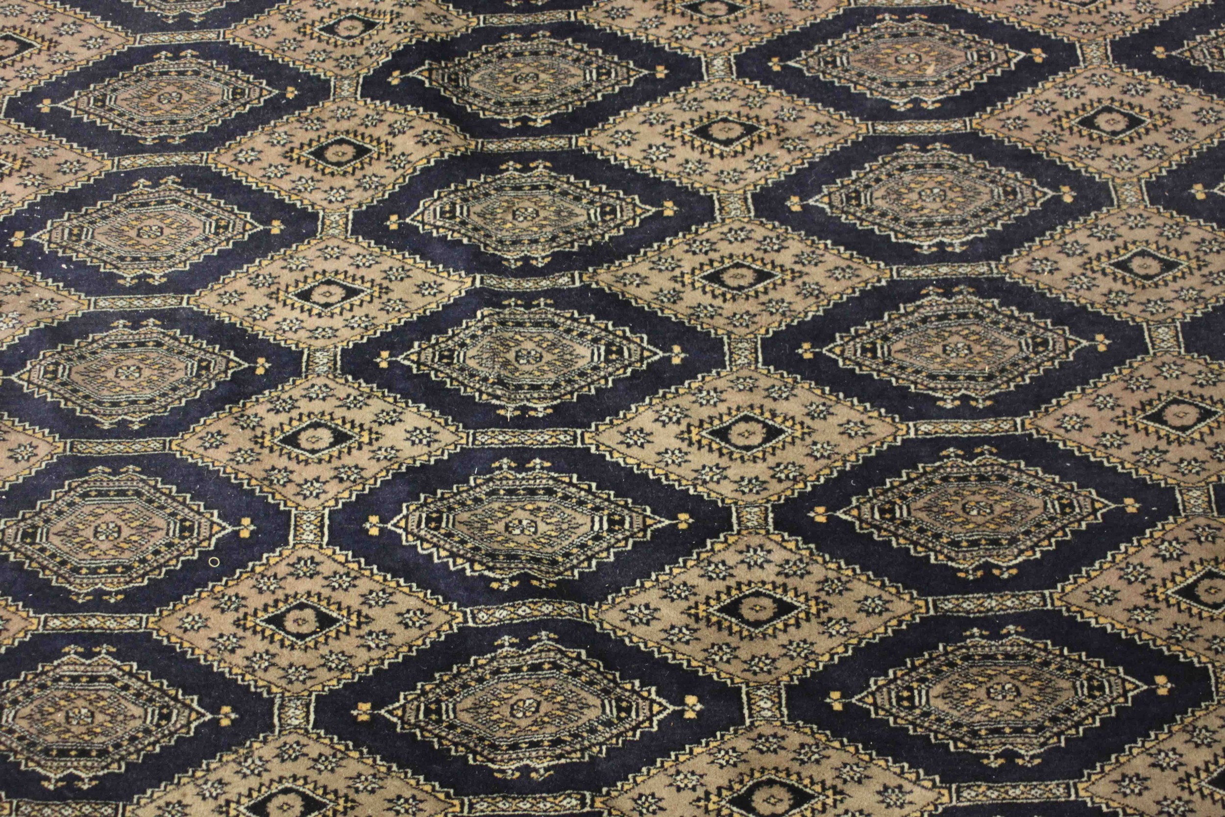 A hand made blue ground Bokhara carpet. L.460 W.310cm. - Image 4 of 7