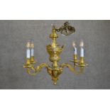 An Edwardian gilt metal classical design six branch chandelier with stylised foliate and figural