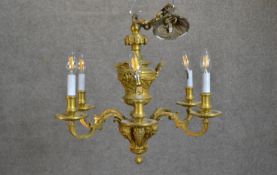An Edwardian gilt metal classical design six branch chandelier with stylised foliate and figural