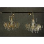 A pair of contemporary gilt brass and Swarovski Spectra crystal drop eight branch chandeliers