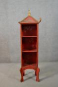 A set of circa 1920s Chinese style bookshelves, red painted with landscape designs, with a