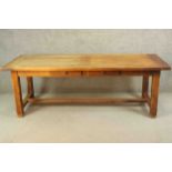 A French oak refectory dining table, the rectangular plank top with cleated ends, over short