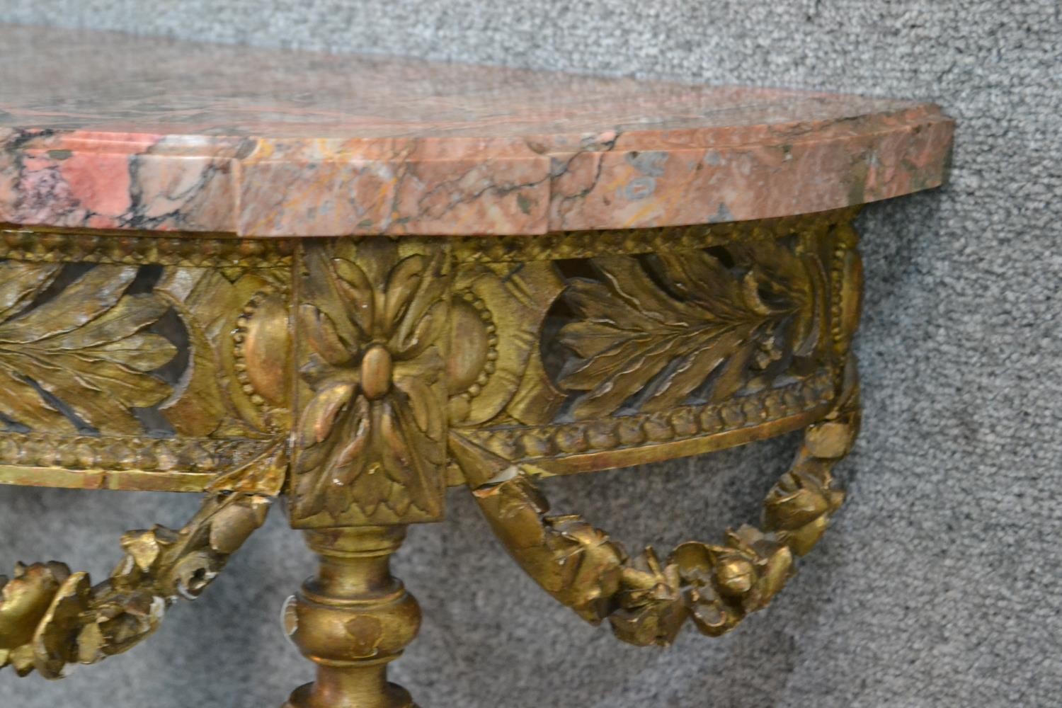 A carved gilt console table with demi lune pink marble top above fluted tapering supports and all - Image 7 of 7