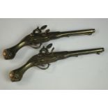 A pair of brass decorative duelling pistols. L.43 (each)