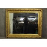 A large ornately decorated wall or pier mirror in rectangular frame with bevelled edge plate. H.