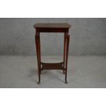 An Edwardian walnut occasional table, with a shaped rectangular top, on slender cabriole legs,
