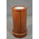 A Victorian mahogany cylindrical bedside cabinet, with an inset white marble top and moulded edge,