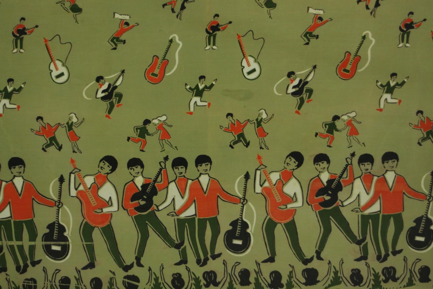 A framed and glazed piece of unused vintage fabric from the 1960's featuring The Beatles, red and