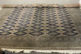 A hand made blue ground Bokhara carpet. L.460 W.310cm.