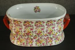 A Victoria Ware ironstone footbath, transfer printed with polychrome flowers, with twin handles. H.