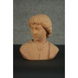 A 19th century style terracotta bust of a young boy, unsigned. H.30 W.27 D.14cm.