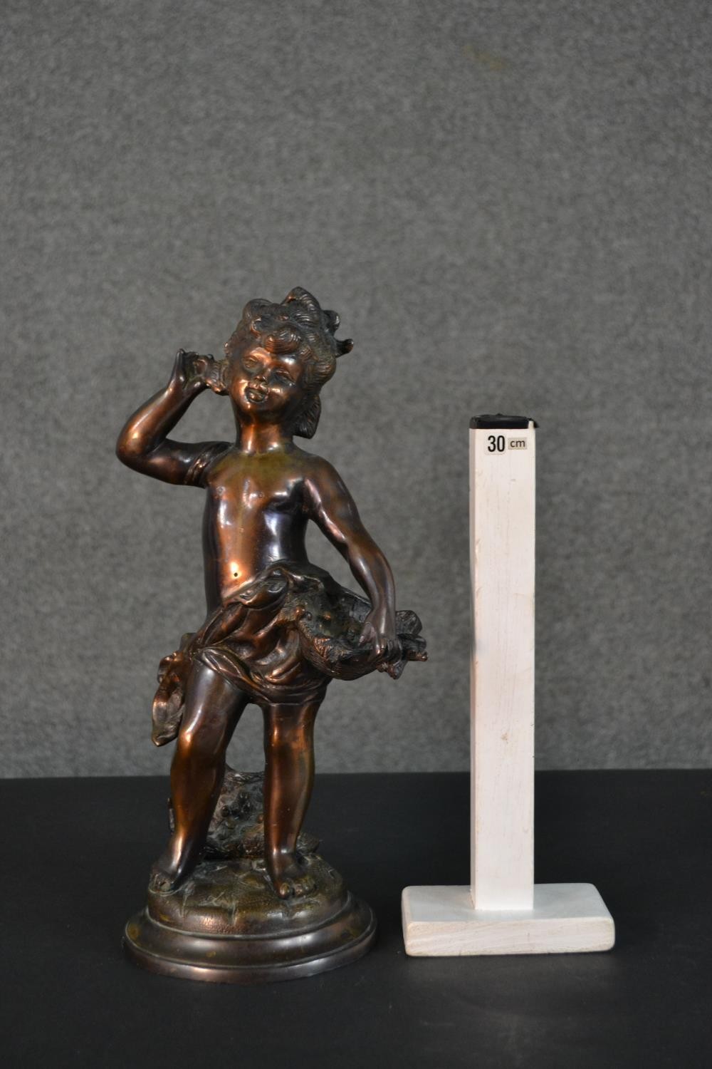 A spelter figure of a classical style putti with a basket of flowers. H.37cm - Image 2 of 8