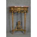 A carved gilt console table with demi lune pink marble top above fluted tapering supports and all