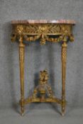 A carved gilt console table with demi lune pink marble top above fluted tapering supports and all