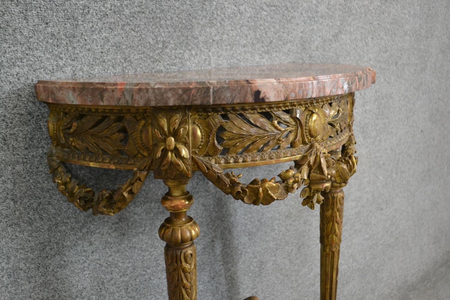 A carved gilt console table with demi lune pink marble top above fluted tapering supports and all - Image 5 of 7