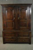 A late 17th to early 18th century oak housekeepers cupboard converted to a wardrobe, with a pair