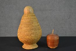 A woven African tribal vessel along with a smaller woven lidded pot. H.33cm (largest)