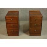 A pair of mid 20th century bedside chests, with a gallery back over three long drawers, on a
