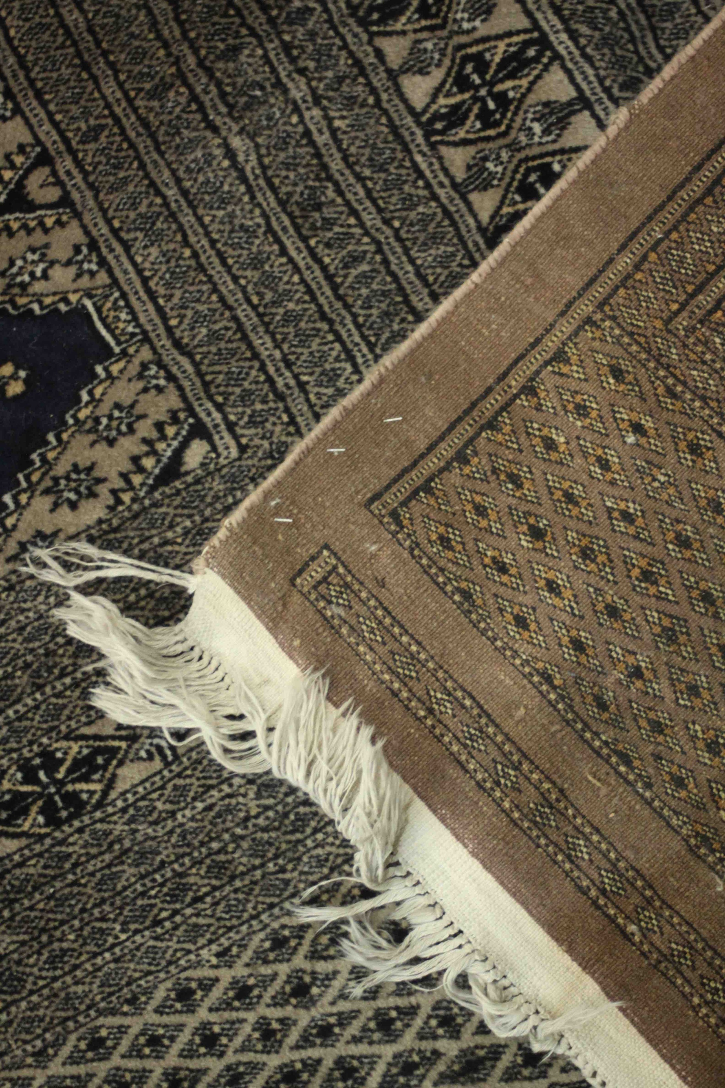 A hand made blue ground Bokhara carpet. L.460 W.310cm. - Image 5 of 7