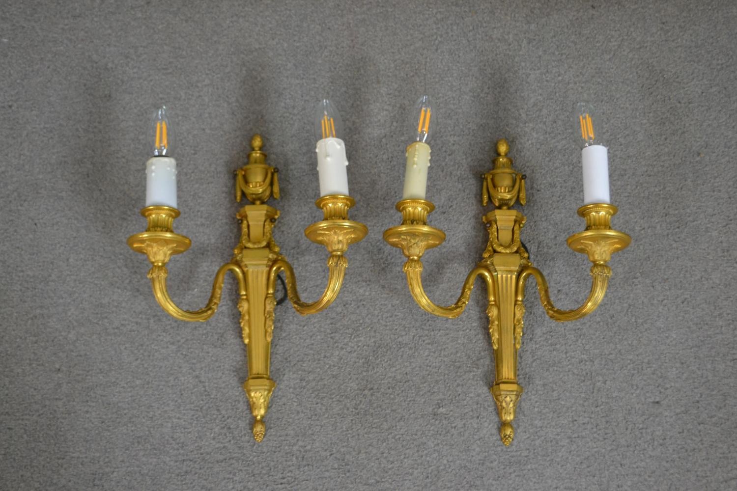 A pair of 19th century gilt metal two branch wall sconces with swag and foliate design. H.39 W.49cm