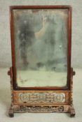 A 19th century Chinese dressing mirror on carved and pierced stand. H.82 W.53. D.23cm.