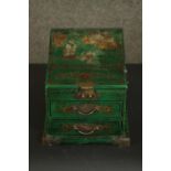 A contemporary Chinese travel dressing chest, green with painted gilt details, the lid opening to