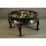 A 20th century Chinese black lacquered circular coffee table, the top inlaid with mother of pearl