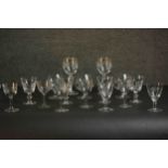 A collection of sixteen hand cut glass and crystal glasses, including a set of four engine decorated