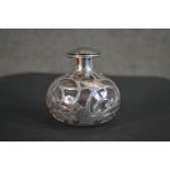 A Victorian glass perfume bottle with a pierced silver overlay in an Art Nouveau inspired design.