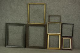 A collection of eight various picture frames, including gilded examples, and a carved wood frame.