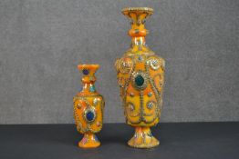 Two Buddhist gemstone set and brass studded beeswax vases. H.47cm (largest)