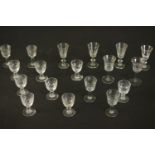 A collection of eighteen hand cut crystal and glass sherry and port glasses, including a set of