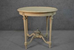 A French Louis XVI style white painted gueridon table, of circular form, the top with a beaded