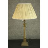 A 20th century brass Corinthian column table lamp, on a square step down plinth base, with an