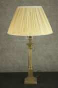 A 20th century brass Corinthian column table lamp, on a square step down plinth base, with an