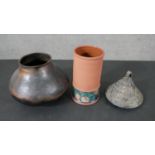 A collection of art pottery, including a gold crackle raku tea pot, a bronze glaze vase on three