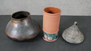 A collection of art pottery, including a gold crackle raku tea pot, a bronze glaze vase on three