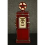 A red painted CD rack in the form of a vintage style American gasoline pump. H.66 W.22 D.19cm.