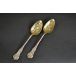 A pair of Victorian James and William Marshall Scottish silver berry spoons with gilded bowls and